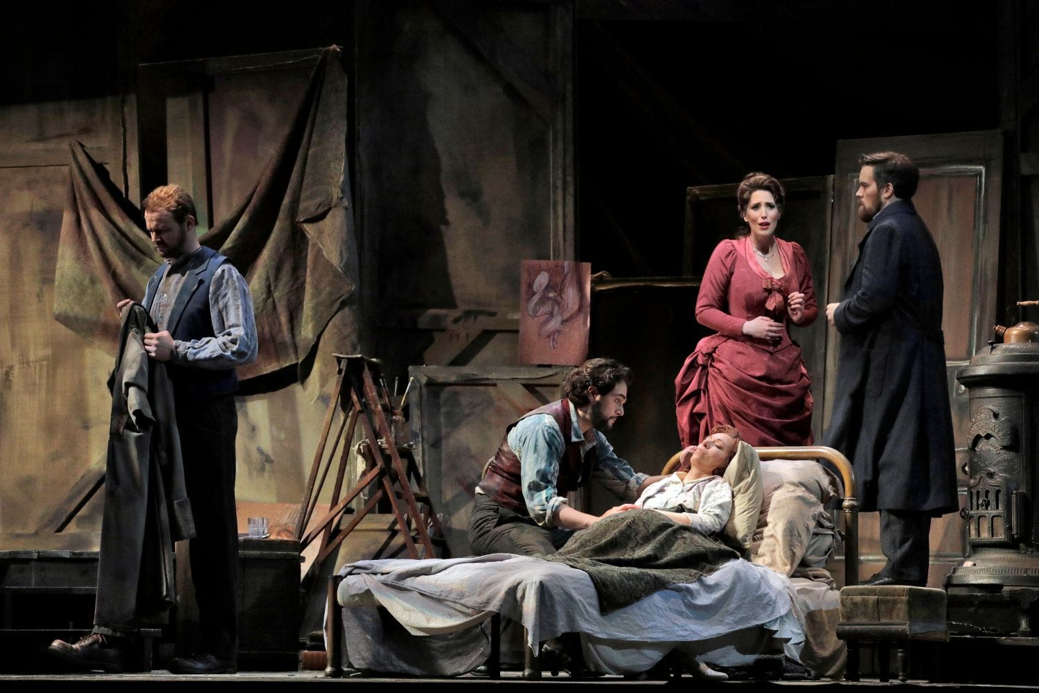 In an artists apartment, a woman lays near dying with a man at her bedside.